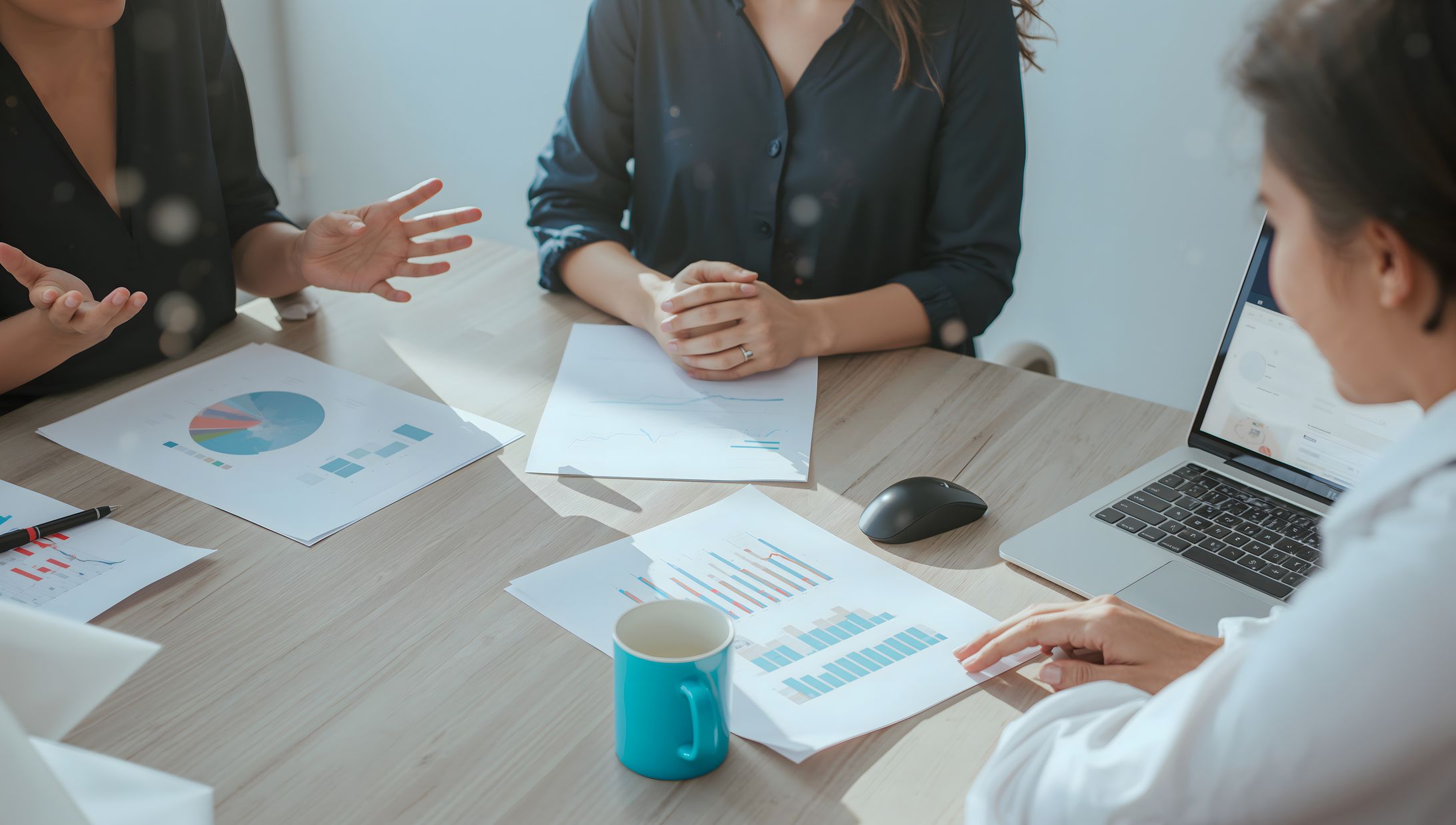 business meeting two people office desk charts laptop (2)-1