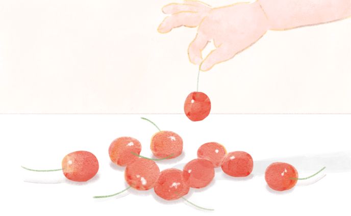 さくらんぼを摘むこども